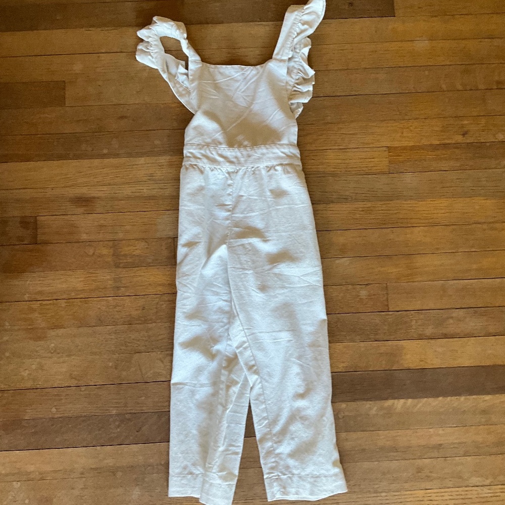 White jumpsuit with ruffled sleeves